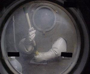 A person is using Rad Release in a sealed chamber to lower nuclear contamination levels